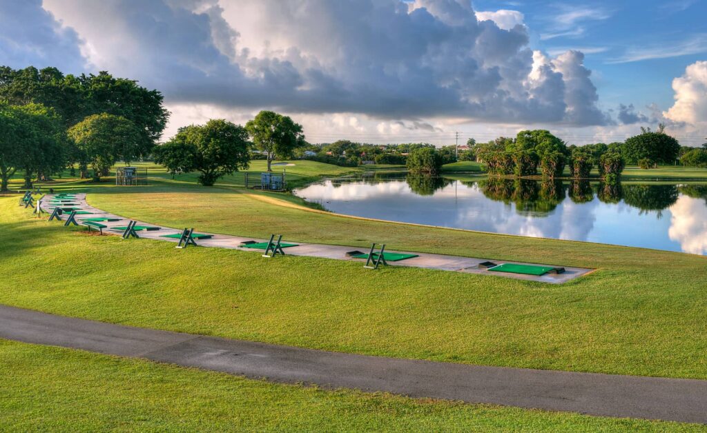 Multiple tee boxes aiming out into the water at the driving range.